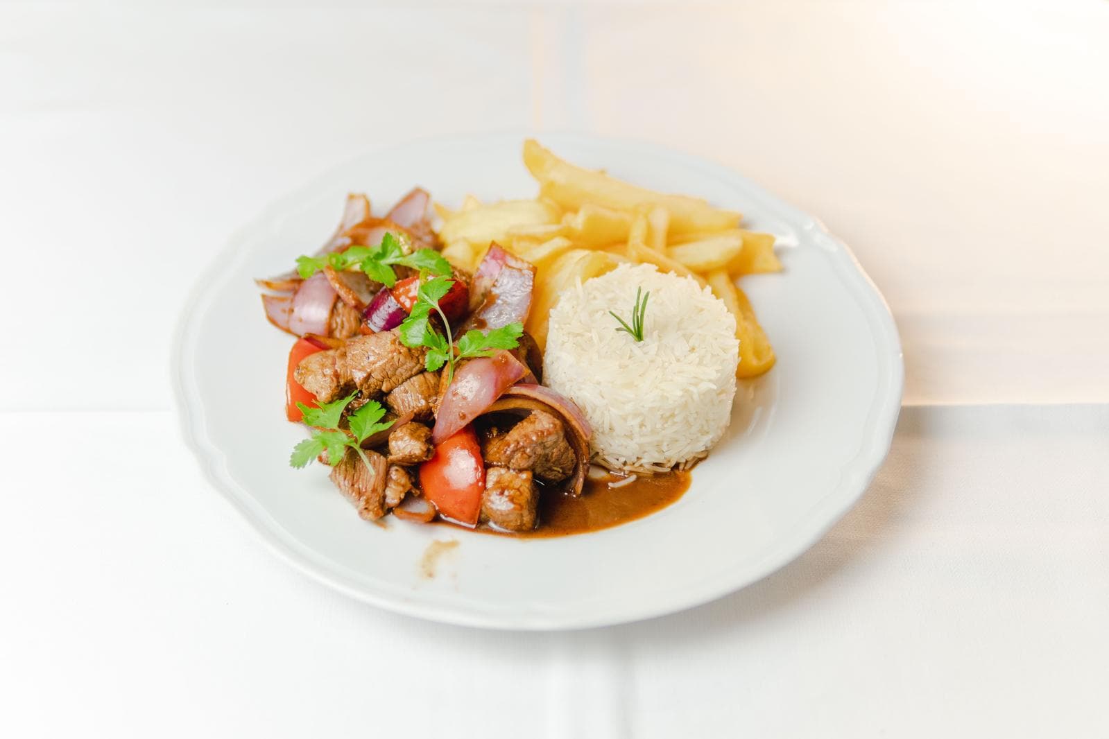 Lomo saltado with rice and fries