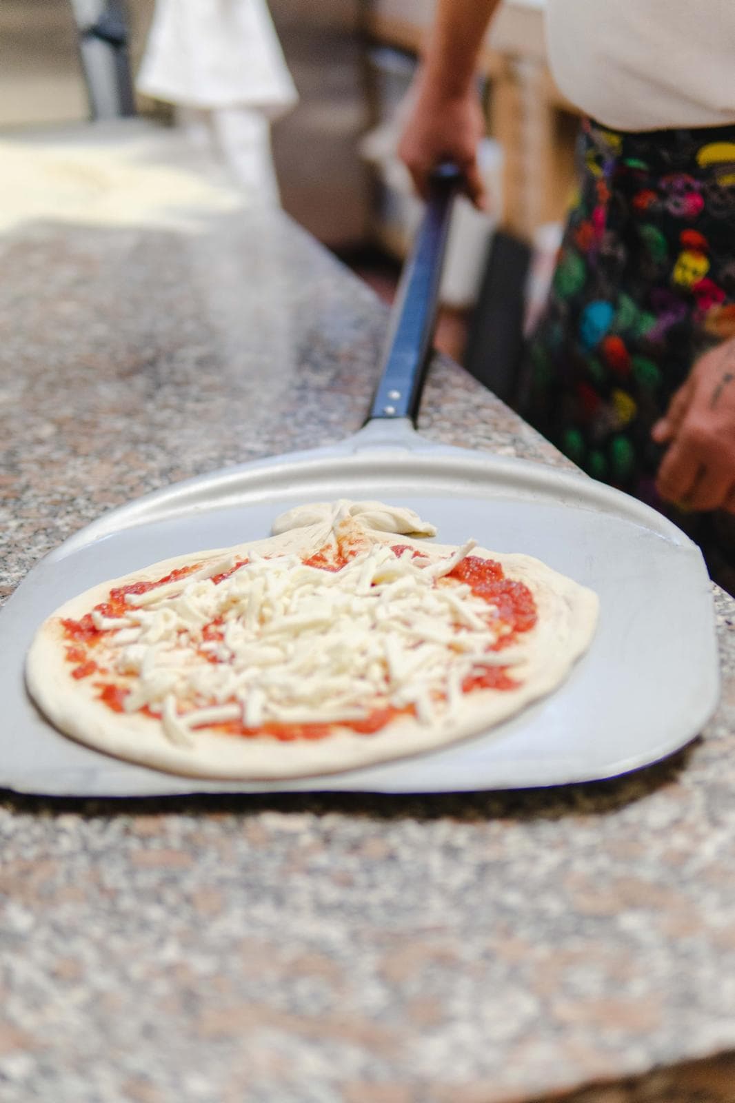 A pizza about to go into the oven