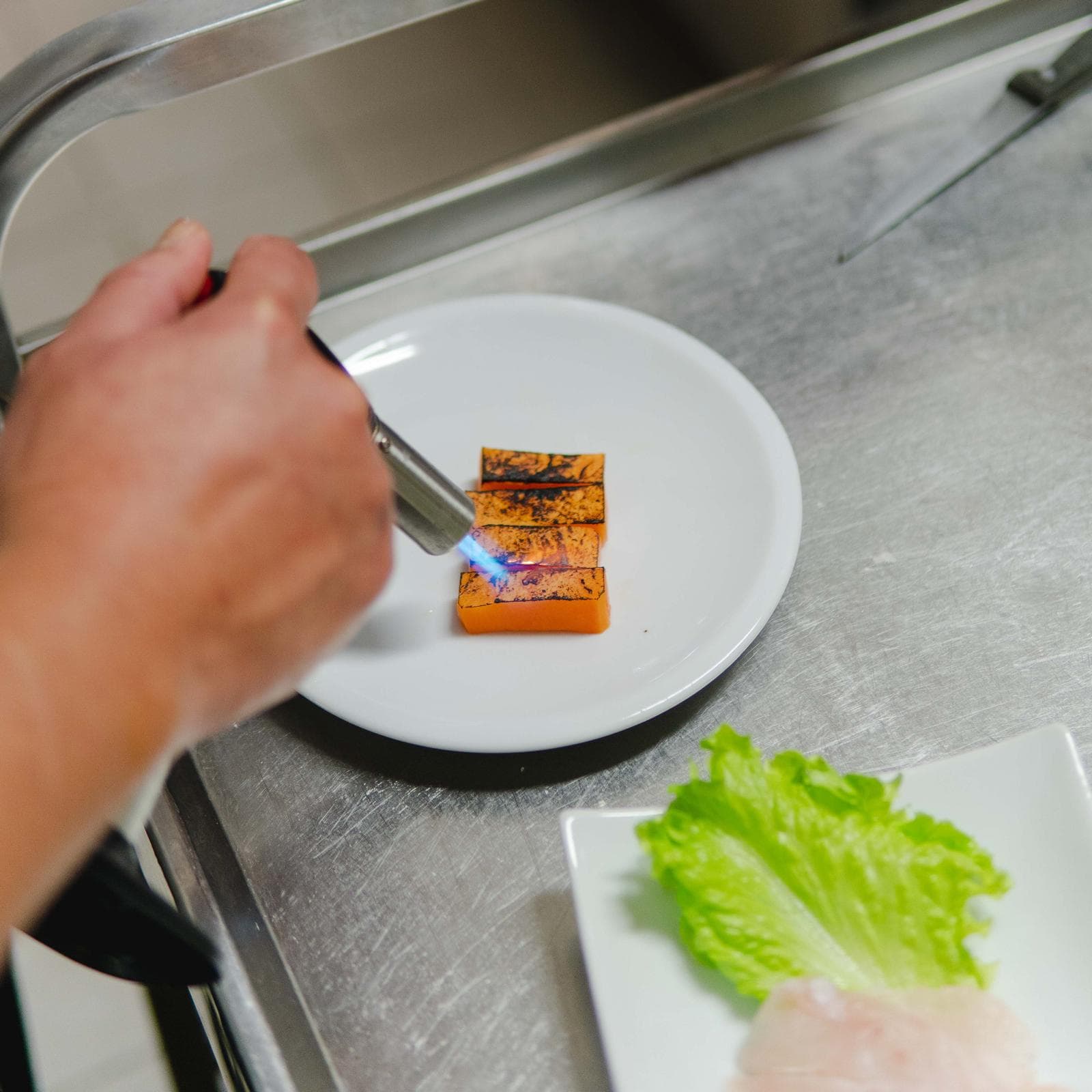 Finishing a dish with a blowtorch